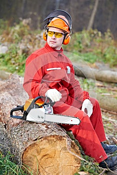 Lumberjack Worker With Chainsaw In The Forest