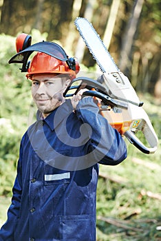 Lumberjack worker with chainsaw in the forest