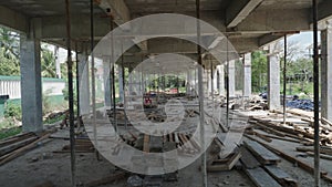 Lumbers And Formworks Under Concrete Slab Of Unfinished Building Supported By Shoring Jacks. dolly shot