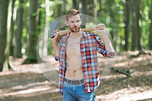 Lumbersexual trend. Bearded man carry axe natural landscape. Sexy guy wear open plaid shirt with masculine look