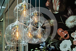 Luminaires with transparent shades and dark glass light bulbs photo