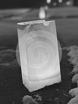 A luminara candle in a paper bag during the holidays