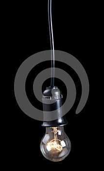 Luminescent electric lamp in receptacle on black