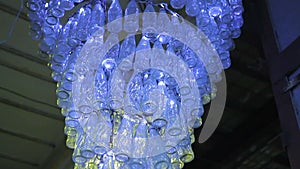 Luminous contemporary installation of glass bottles, which will go for recycling