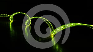 Luminous LED decorative strip of green color on a black background