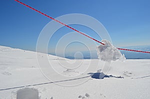 Lump of snow on red rope