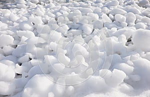 Lumps of snow and ice frazil on the surface of the freezing rive