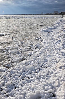 Lumps of snow and ice frazil on the surface of the freezing rive