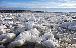 Lumps of snow and ice frazil on the surface of the freezing rive