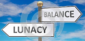 Lunacy and balance as different choices in life - pictured as words Lunacy, balance on road signs pointing at opposite ways to