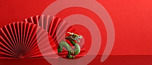 Lunar New Year 2024 background. Chinese dragon with red paper fans on red background photo