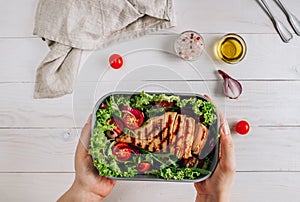 Lunch box with chicken and salad, ready to go for work or school. Meal preparation or dieting concept