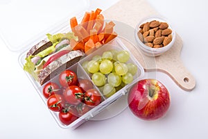 Lunch box with fresh vegetables and fruits.