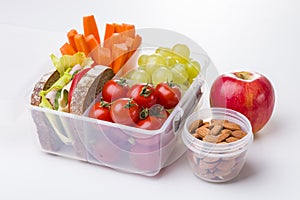 Lunch box with fresh vegetables and fruits.