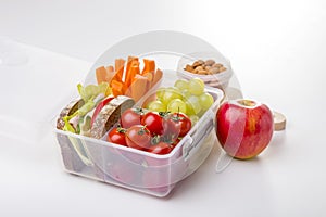 Lunch box with fresh vegetables and fruits.