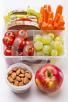 Lunch box with fresh vegetables and fruits.