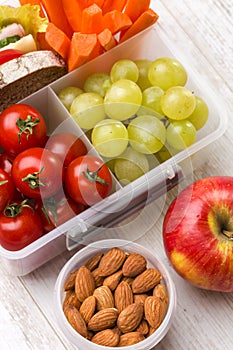 Lunch box with fresh vegetables and fruits.