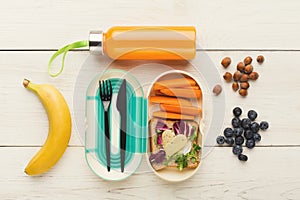 Lunch box with healthy food on white table background