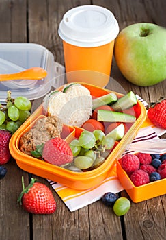 Lunch box with sandwich, cookies, veggies and fruits