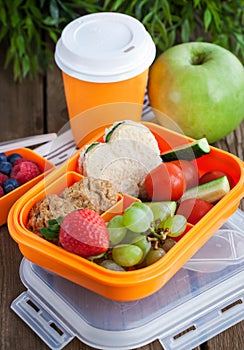 Lunch box with sandwich, cookies, veggies and fruits