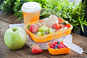 Lunch box with sandwich and fruits