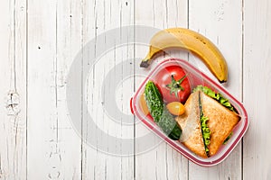 Lunch box with sandwich, vegetables and banana