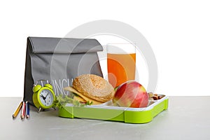 Lunch box with tasty sandwich, glass of drink