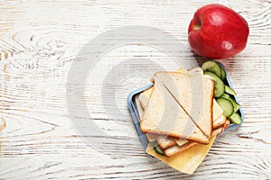 Lunch box with tasty sandwich