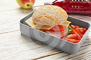 Lunch box with tasty sandwich