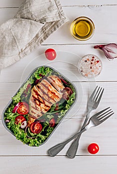 Lunch boxes with chicken and salad, ready to go for work or school. Meal preparation or dieting concept