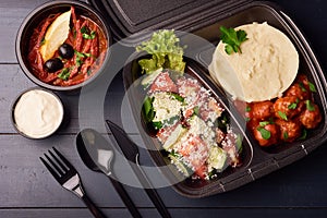 Lunch boxes with food ready to go for work or school, or dieting concept, mashed potatoes with meat balls and soup