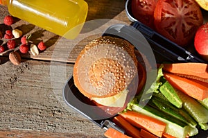 Lunch boxes with food ready to go for work or school, meal preparation or dieting concept. Hamburgers with lettuce