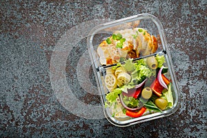 Lunch boxes with grilled chicken breast and pasta salad with fresh vegetables