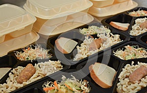 Lunch boxes salad, chicken leg, pasta. Free lunches for needy and internally displaced persons. Lunch delivery concept. Online
