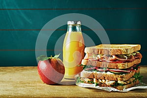 Lunch food set with sandwich, orange juice, apple
