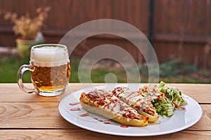 Lunch in the garden restaurant. Stuffed white sweet paprika and pilsner beer. photo