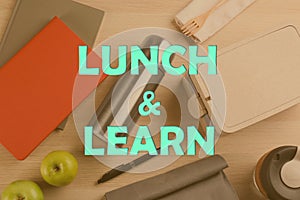 Lunch and Learn concept. Flat lay composition with thermos, food and stationery on wooden table