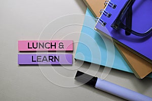 Lunch and Learn text on sticky notes isolated on office desk