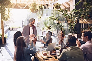 Lunch is on me to say thanks for the hardwork. a group of creative workers having a meeting over lunch in a cafe.