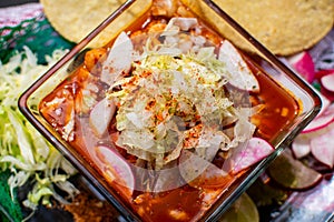 Lunch with a Mexican menudo soup, vegetables and chips
