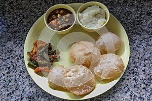 Lunch Plate Puri Pindi Choley Phirni and Aloo Bhindi Sabji Lokgram Kalyan