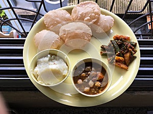 Lunch Plate Puri Pindi Choley Phirni and Aloo Bhindi Sabji Lokgram Kalyan