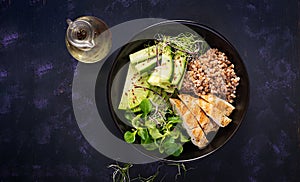 Lunch salad. Buddha bowl with buckwheat porridge, grilled chicken fillet, corn salad, microgreens and daikon. Healthy food. Top