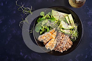 Lunch salad. Buddha bowl with buckwheat porridge, grilled chicken fillet, corn salad, microgreens and daikon. Healthy food. Top