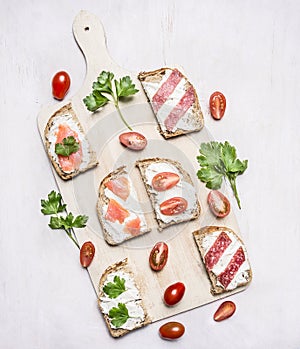 Lunch with sandwiches and herbs wooden rustic background top view