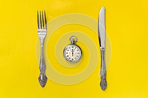 Lunch time concept. Clock with knife and fork