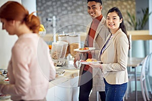 Lunch time.Man and woman having lunch at office cafeteria photo