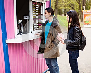 Lunch time. Young couple buying coffee