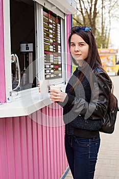 Lunch time. Young woman buying coffee