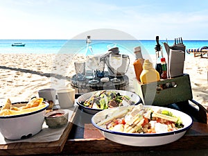 Lunch on the tropical beach on turquoise sea background.